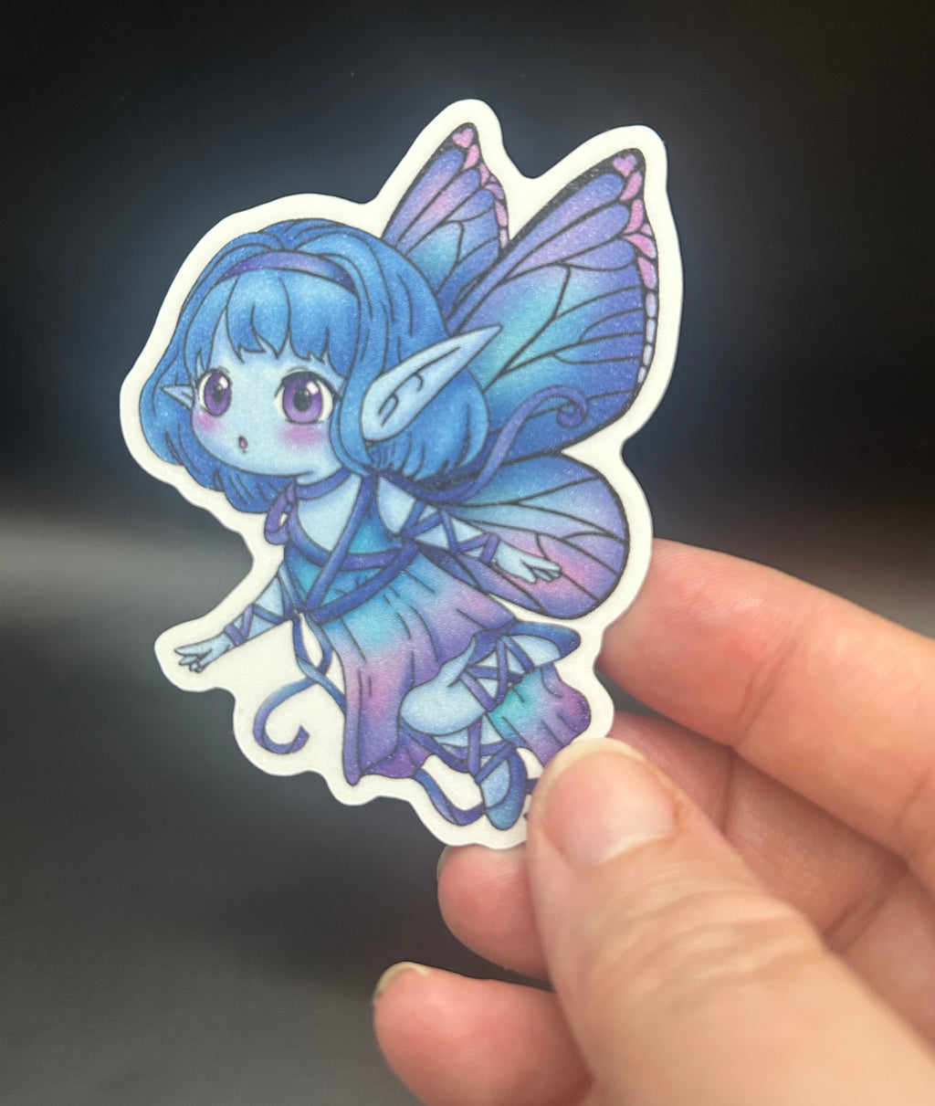 A die-cut sticker featuring a cute chibi fairy with blue hair and purple wings